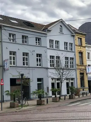 a white building on the side of a street at Anna Penthouse in Ghent