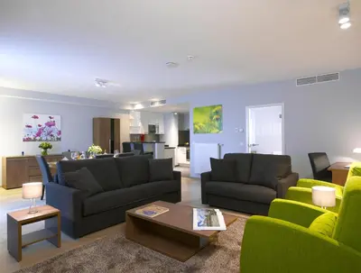a living room with two couches and a table at Thon Residence Florence Aparthotel in Brussels