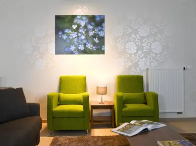 a living room with two green chairs and a table at Thon Residence Florence Aparthotel in Brussels
