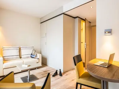 a living room with a table and a couch at ibis Styles Hotel Brussels Centre Stéphanie in Brussels