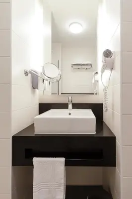 a bathroom with a white sink and a mirror at ibis Styles Hotel Brussels Centre Stéphanie in Brussels