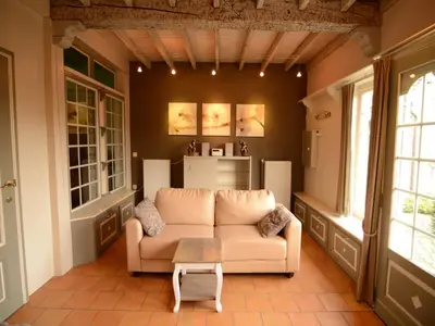 a living room with a couch and a table at Holiday Home in Zele near Laarne Castle in Zele