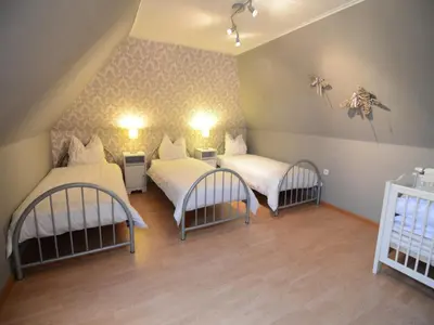 a room with two beds and two chairs at Holiday Home in Zele near Laarne Castle in Zele