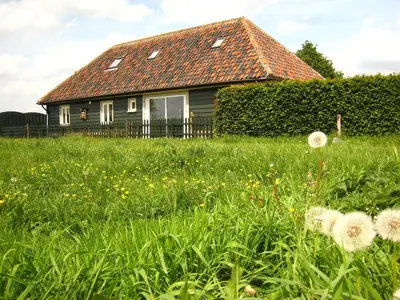 a house with a field of grass and flowers at Holiday Home in Zele near Laarne Castle in Zele