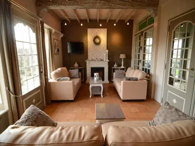 a living room with couches and a fireplace at Holiday Home in Zele near Laarne Castle in Zele