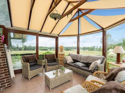 an open living room with windows and couches at Charming Nieuwpoort Mill Retreat in Zottegem