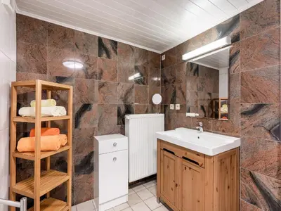 a bathroom with a sink and a mirror at Charming Nieuwpoort Mill Retreat in Zottegem