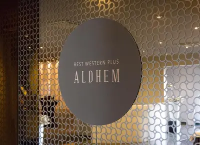 a sign on a glass door with the words best western plus adher m at Best Western Plus Aldhem Hotel in Grobbendonk