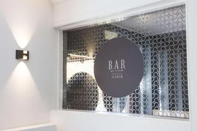 a glass window with a bar limit sign on it at Best Western Plus Aldhem Hotel in Grobbendonk