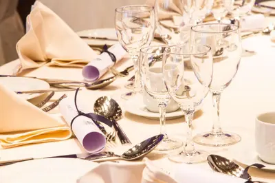 a table with wine glasses and silverware on it at Best Western Plus Aldhem Hotel in Grobbendonk