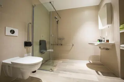 a bathroom with a toilet and a glass shower at Let's Meet Elewijt in Elewijt