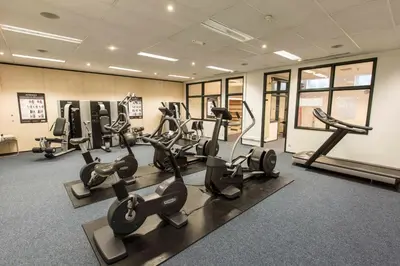 a gym with treadmills and exercise equipment in a room at Let's Meet Elewijt in Elewijt