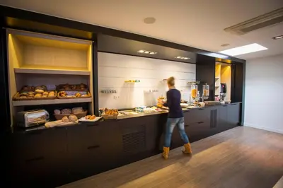 a woman standing at a counter in a kitchen at Let's Meet Elewijt in Elewijt
