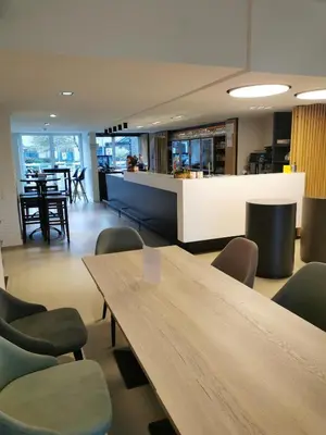 a meeting room with a wooden table and chairs at Let's Meet Elewijt in Elewijt