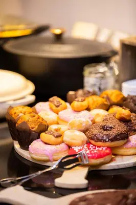 a plate of different types of donuts on a table at Let's Meet Elewijt in Elewijt