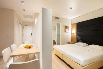 a bedroom with a bed and a table with a bowl of fruit on it at B-aparthotel Grand Place in Brussels