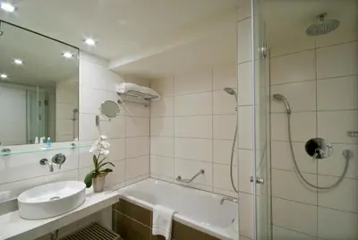 a bathroom with a tub and a sink and a shower at B-aparthotel Grand Place in Brussels