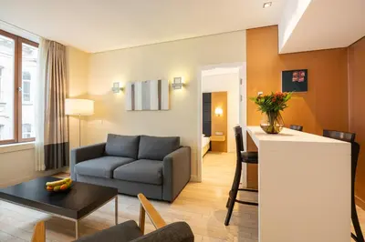 a living room with a couch and a table at B-aparthotel Grand Place in Brussels