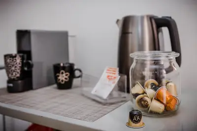 a jar on a counter next to a coffee pot at Viktoria Guesthouse in Westerlo