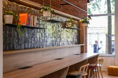 a bar in a restaurant with a brick wall at B&B HOTEL Brussels Centre Gare du Midi in Brussels