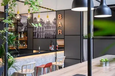 a restaurant with a bar with chairs and a table at B&B HOTEL Brussels Centre Gare du Midi in Brussels