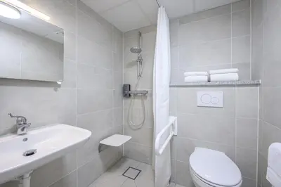 a bathroom with a sink and a toilet and a shower at B&B HOTEL Brussels Centre Gare du Midi in Brussels