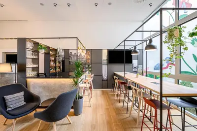 a restaurant with a long table and chairs at B&B HOTEL Brussels Centre Gare du Midi in Brussels