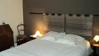 a bedroom with a white bed with two lamps at B&B Chambre Chocolat in Brussels