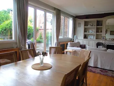 a living room with a table and a couch at B&B Chambre Chocolat in Brussels