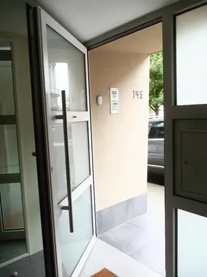 a glass door leading into a building at B&B Chambre Chocolat in Brussels