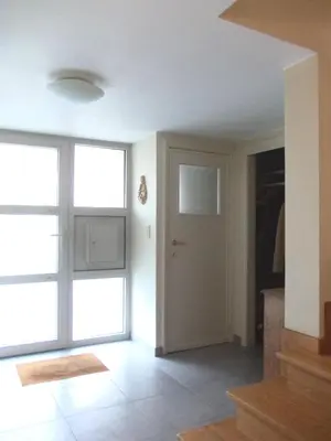 an empty room with a door and a window at B&B Chambre Chocolat in Brussels