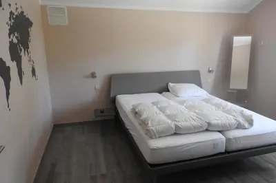 a bed in a small room with a white mattress at t Sutterhuisje, zalig slapen aan het Donkmeer in Donk