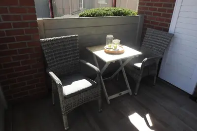 a small table and two chairs on a patio at t Sutterhuisje, zalig slapen aan het Donkmeer in Donk