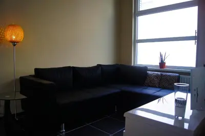 a living room with a couch and a window at All Inn Holiday Home in Ghent