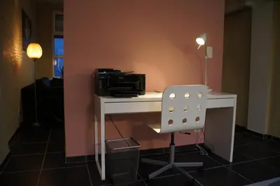 a white desk with a microwave and a chair at All Inn Holiday Home in Ghent