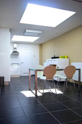 a dining room with a table and four chairs at All Inn Holiday Home in Ghent