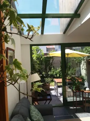 a living room with a sliding glass door to a patio at Quiet apartment in Antwerp near parc - B&B InterMezzo - business & leisure in Antwerp