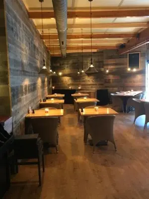 a restaurant with tables and chairs in a room at Hotel Thermen Mineraal in Rijmenam