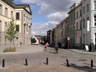 a group of people riding bikes down a street at Designflats Gent in Ghent