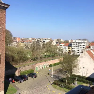 a view of a city with cars parked in a parking lot at Designflats Gent in Ghent