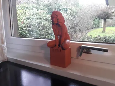 a statue sitting on a window sill in front of a window at Un grand jardin en ville. Chez Guy in Brussels