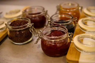 a group of jars of jam on a table at B&B Hof ter Kouter in Dworp