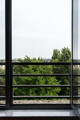 an open window with a view of trees at Diamant Suites Brussels EU in Brussels