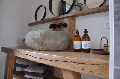 a shelf with two bottles of wine on it at Bed en Bezem in Laarne