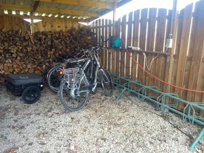 two bikes parked next to a pile of wood at Pluimpapaver Hotel & Glamping in Aarschot