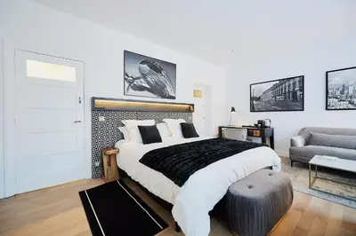 a bedroom with a large bed and a couch at B&B Suites 124 in Brussels