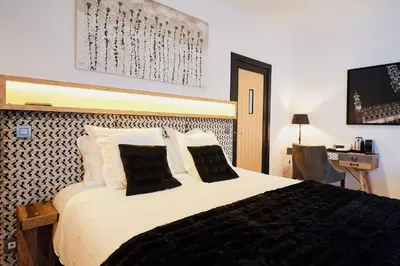 a bedroom with a large bed with a tv on the wall at B&B Suites 124 in Brussels