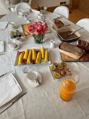 a white table with food and flowers on it at B&B Suites 124 in Brussels