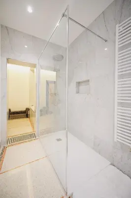 a shower with a glass door in a bathroom at B&B Suites 124 in Brussels