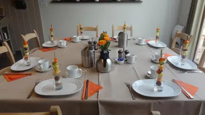 a long table with plates and utensils on it at B&B Het Wouwe in Herentals
